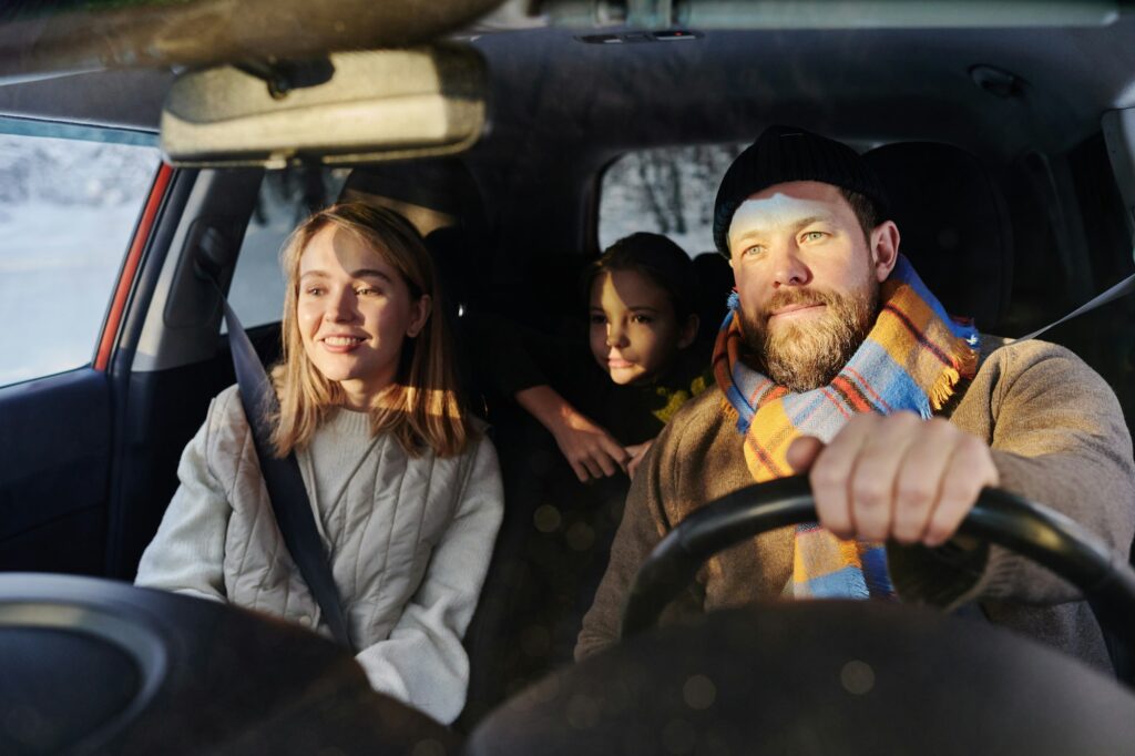 Family travelling by car in winter