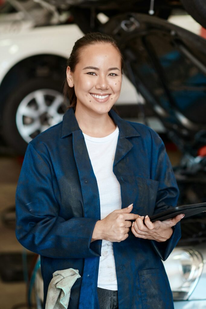 Shot of a female mechanic holding a digital tablet while working in an auto repair shop